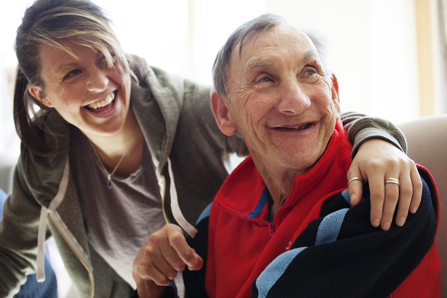 Elderly man shown with a carer.